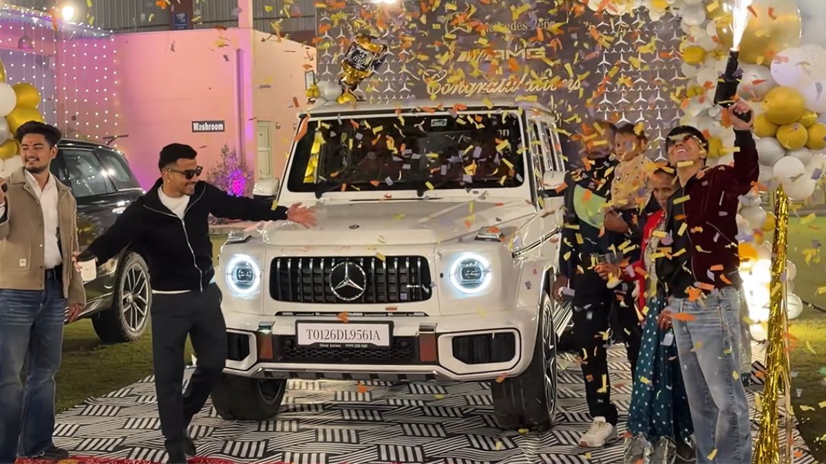 Dinesh Kirola standing with black Mercedes G63 AMG G-Wagon luxury SUV delivery day showroom photo